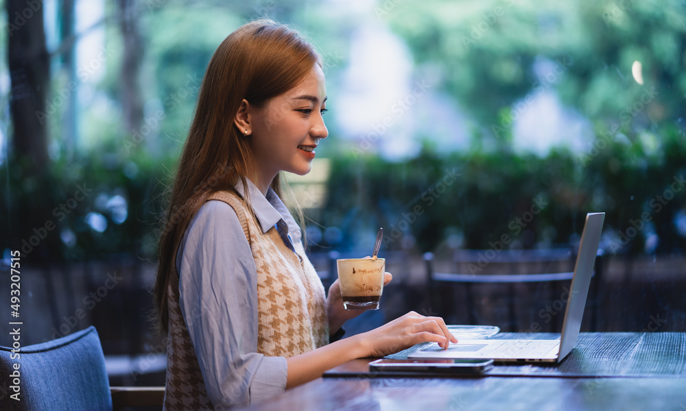 Young Asian business woman working at coffee shop