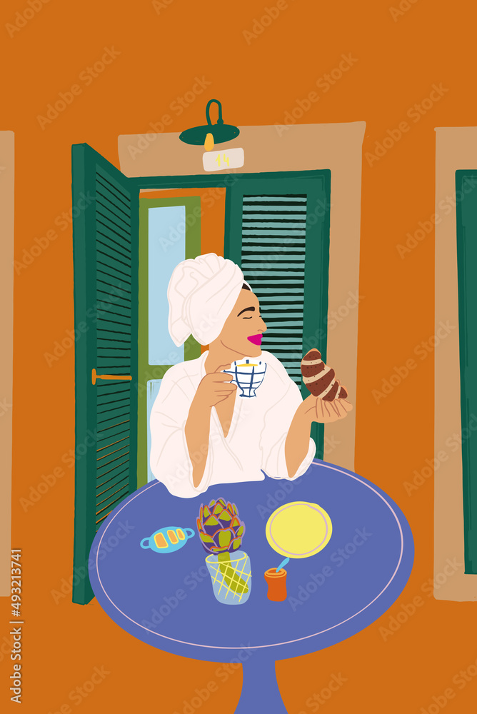 Beautiful woman in bathrobe and towel on her head having a breakfast with coffee and croissants, sit