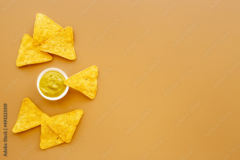 Corn nachos chips with avocado guacamole top view