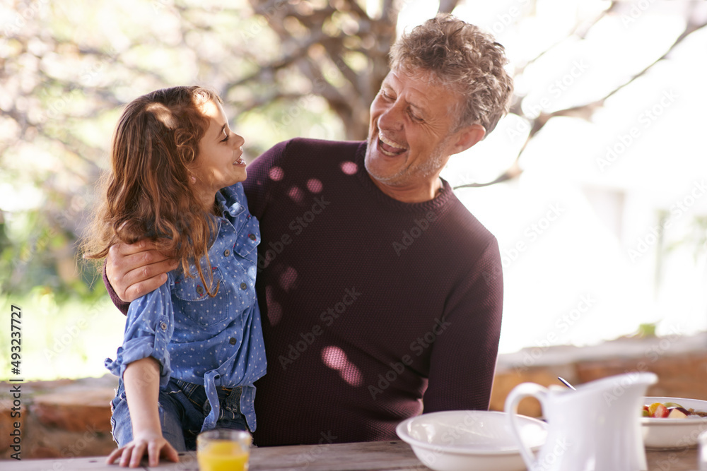 Love you so much my darling. Shot of a little girl and her grandfather having breakfast together out