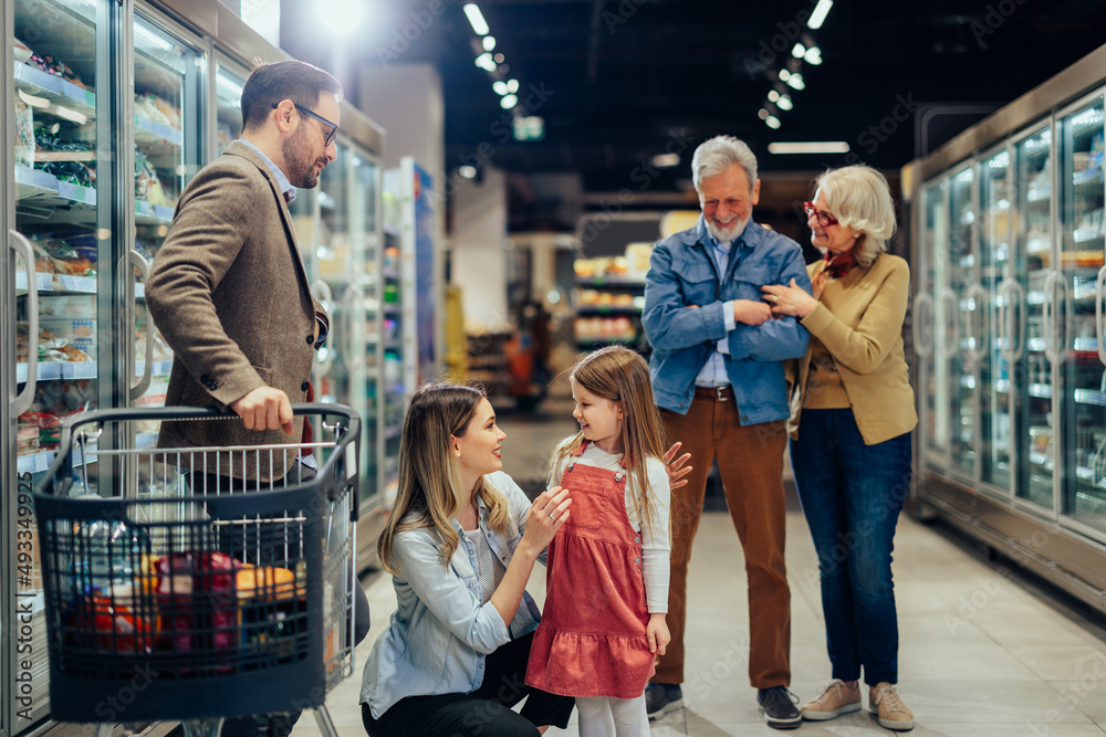 Three generations family shopping in modern supermarket