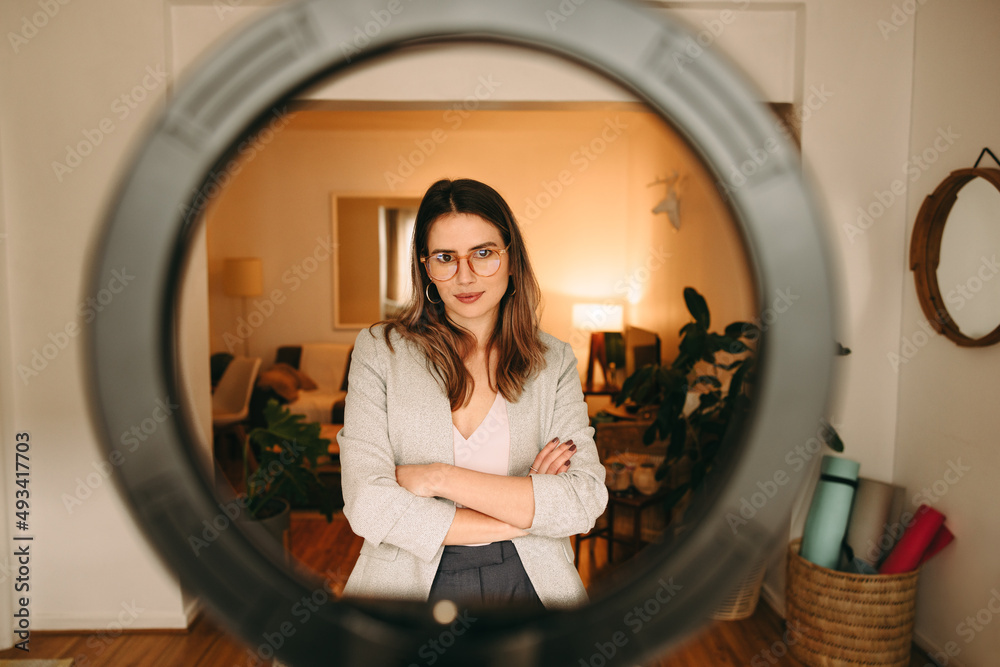 Vlogger standing in front of a ring light at home