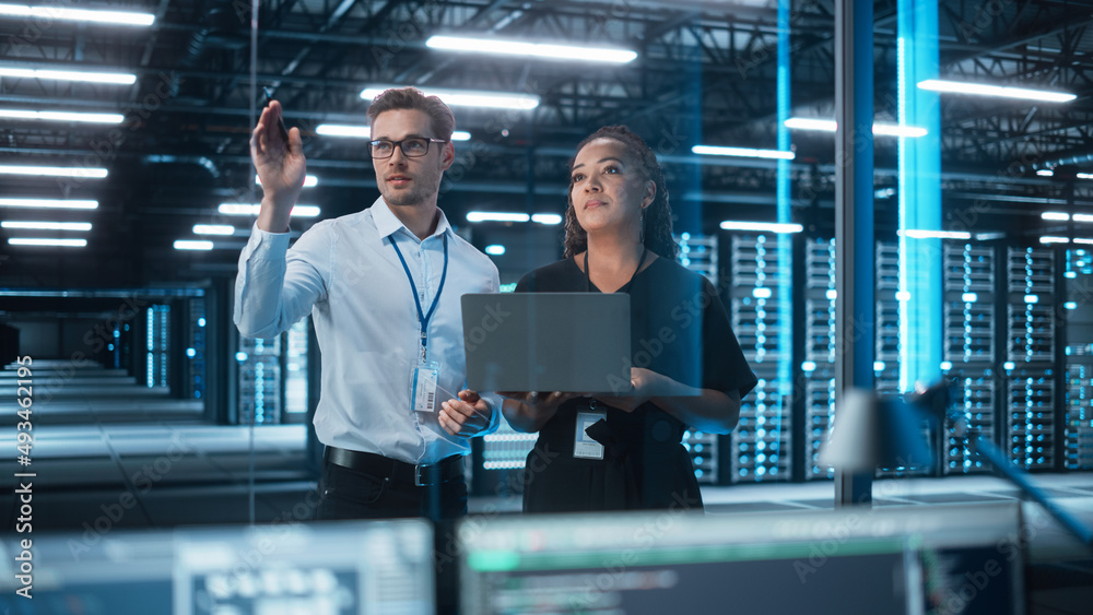 Factory Office Facility: Female Chief Engineer Holds Laptop Computer, Look Away and Brainstorming wi