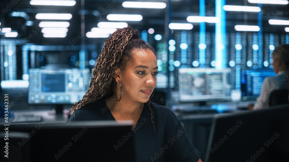 IT Specialists Using Laptop Computer in Data Center. Male Technician and Female e-Business Entrepren