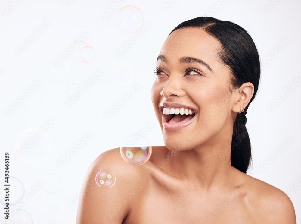 Healthy skin a big part of looking your best. Shot of bubbles floating over a beautiful woman in the