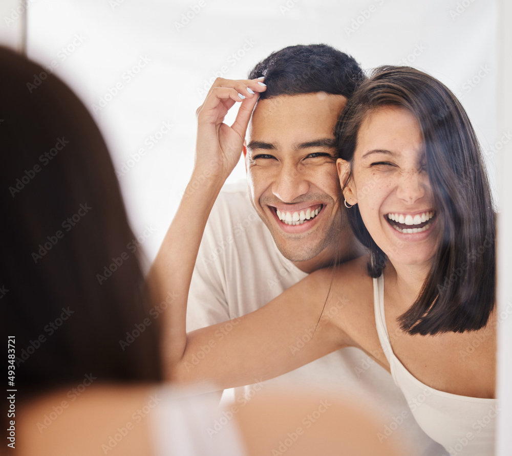 We both woke up on the right side of the bed. Shot of a happy young couple standing together in thei