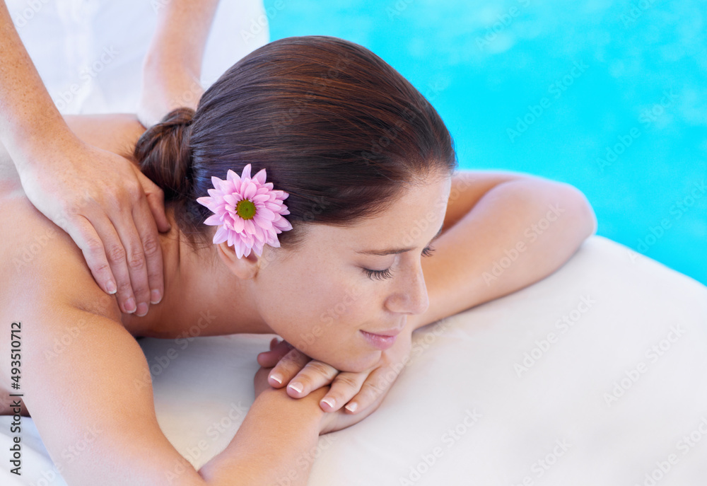 Feeling so pampered. Shot of an attractive young woman,getting a back massage at a spa.