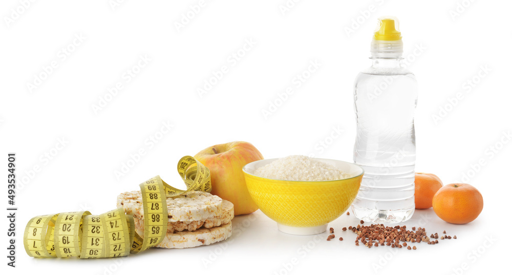 Different healthy products, bottle of water and measuring tape on white background