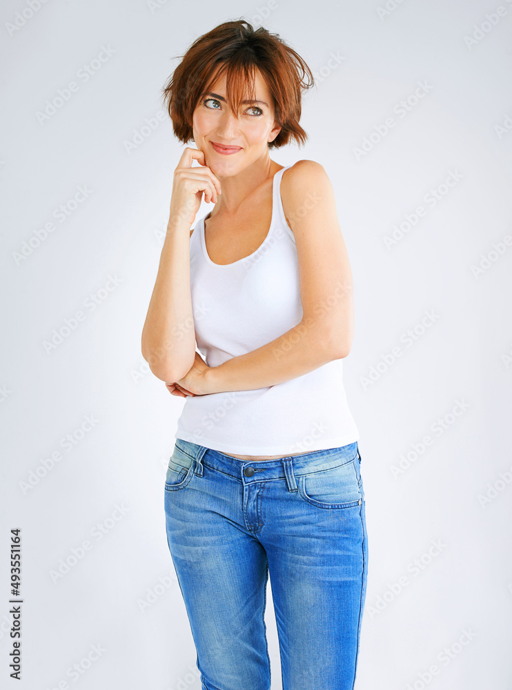 Now youve got me thinking. Studio portrait of a young woman posing against a grey background.