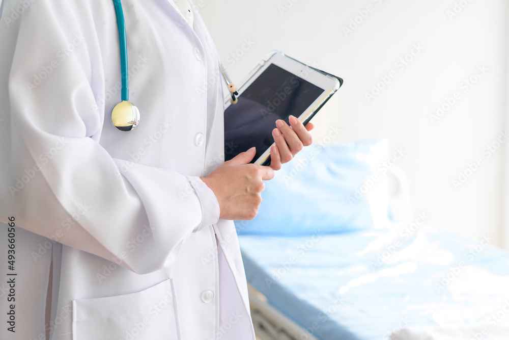 Portrait of young female doctor with stethoscope working at hospital, medical and health care concep