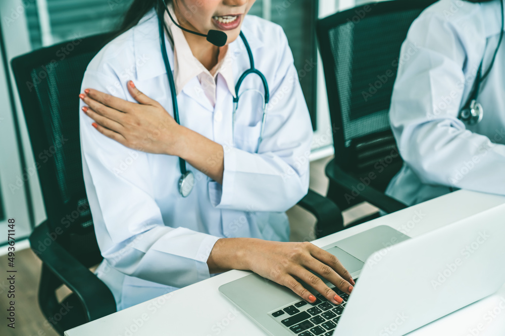 Doctor wearing headset talking actively on video call in hospital or clinic . Concept of telehealth 