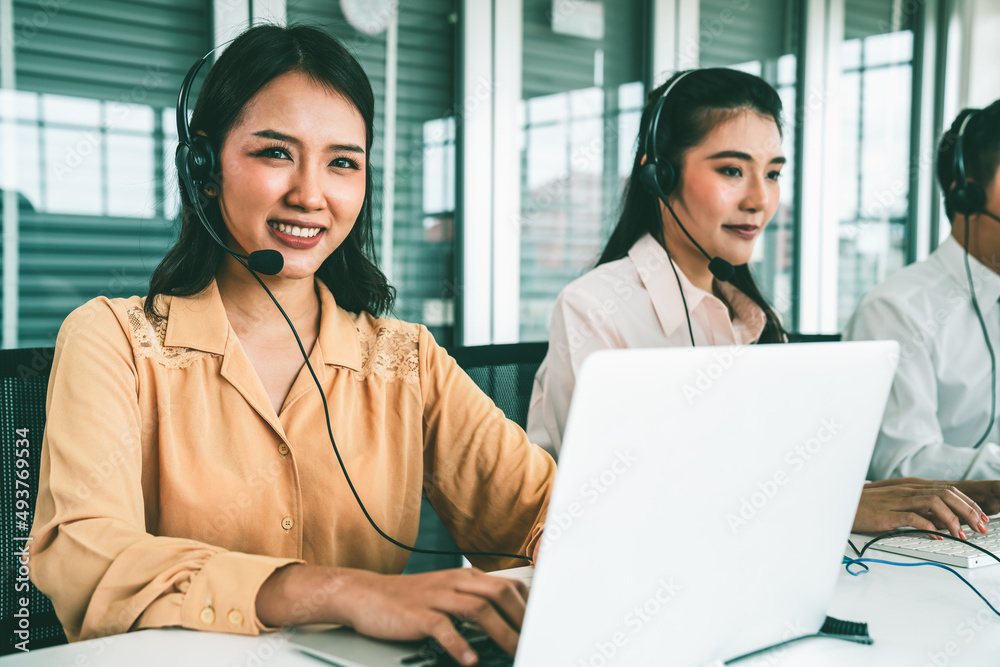 Business people wearing headset working actively in office . Call center, telemarketing, customer su