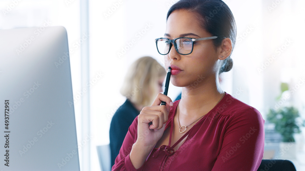 I have to take a minute to think about this. Cropped shot of a focused young businesswoman working o