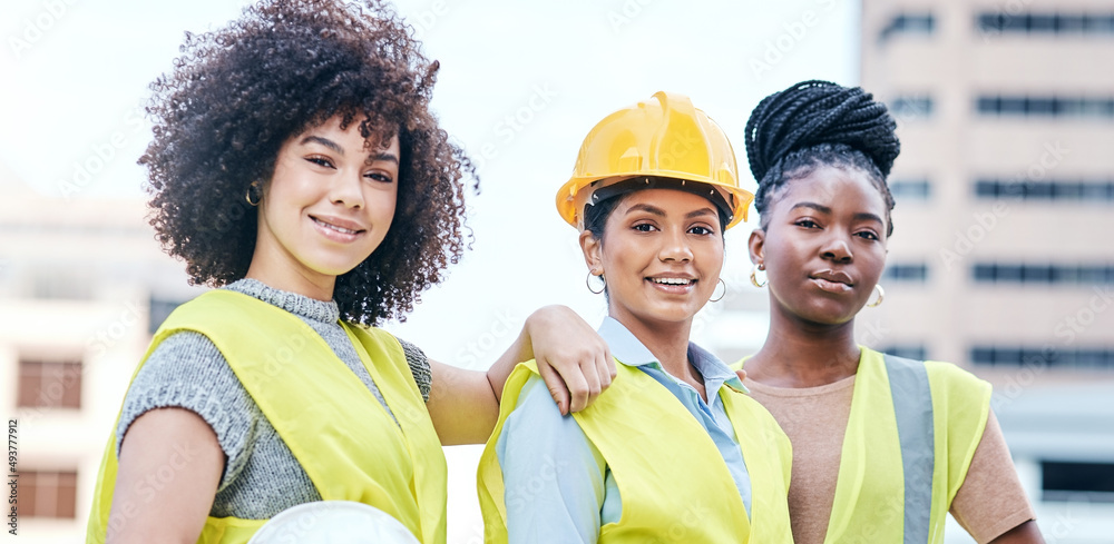 Were giving this city a makeover. Portrait of a group of confident young businesswomen working at a 