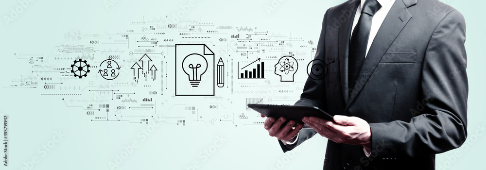 Idea of success theme with businessman holding a tablet computer