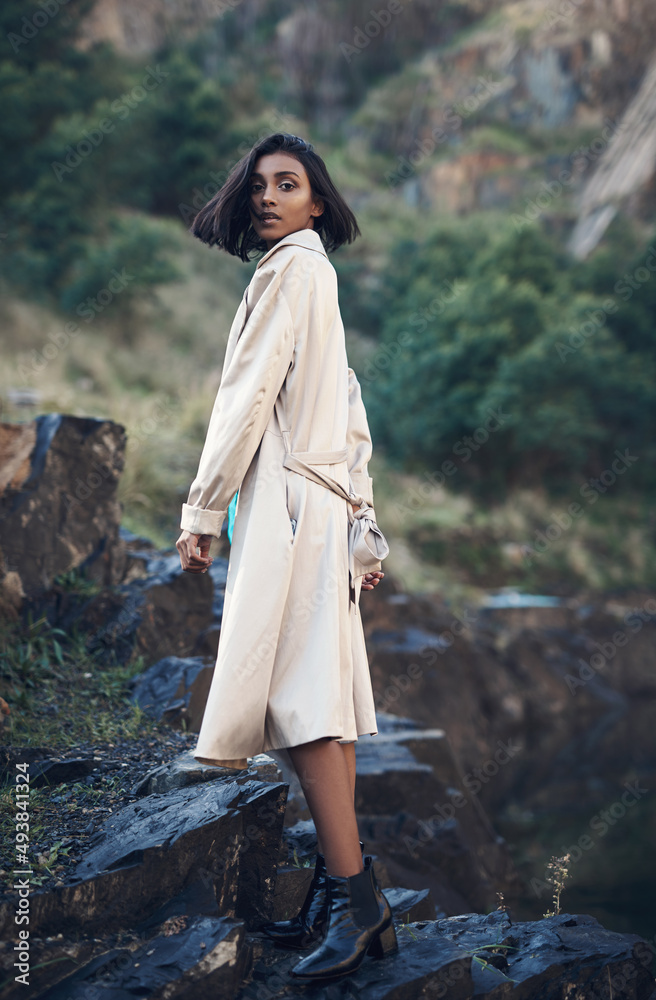 The world is full of beautiful things, like you. Shot of a fashionable young woman posing against a 