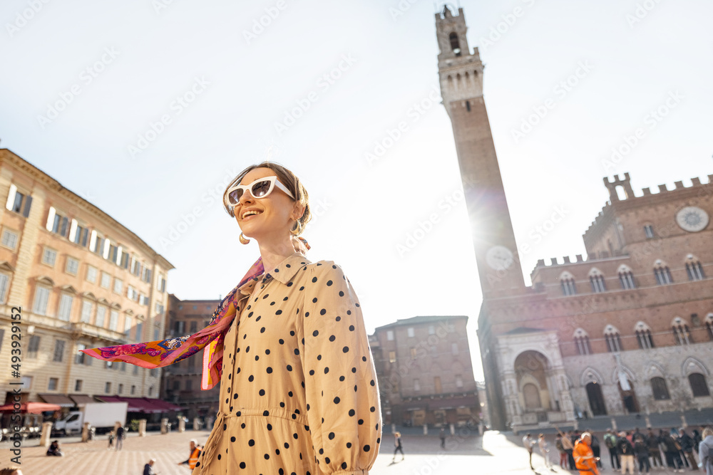 Portrait of a woman on background of town hall of Siena city, traveling famous places in Tuscany. Co