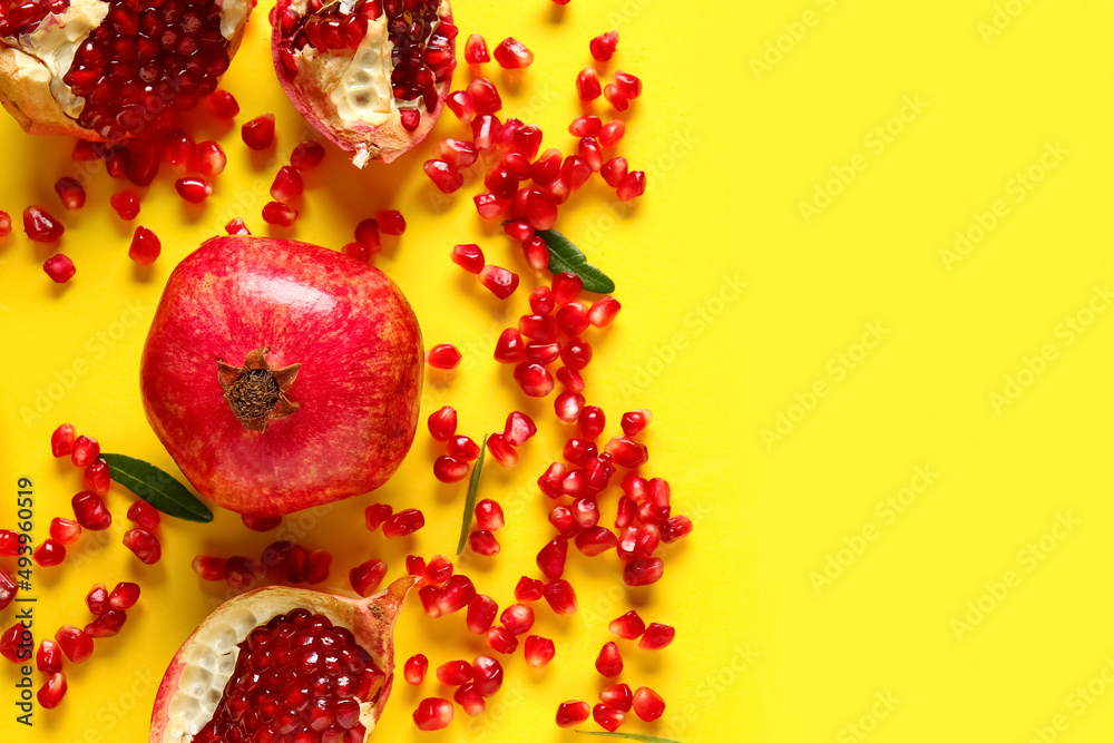 Tasty ripe pomegranate on yellow background