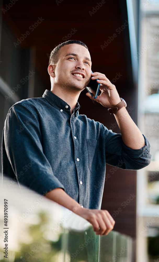 Its time to get your name out there. Shot of a young businessman standing on an office balcony and u