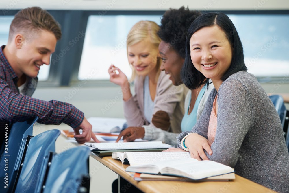 The last exam before the real world begins. A group of students sitting in an exam room.