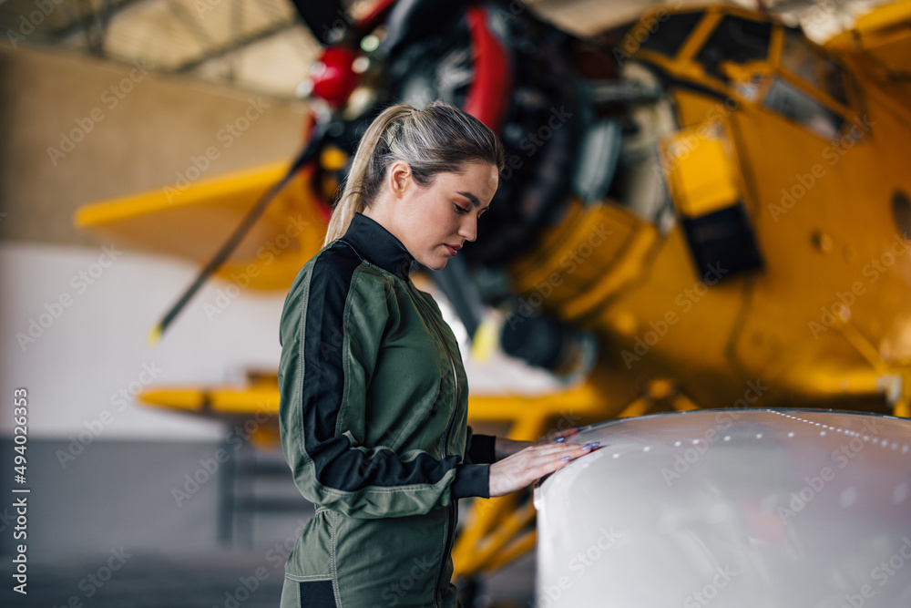 Side view of a female pilot, checking something.