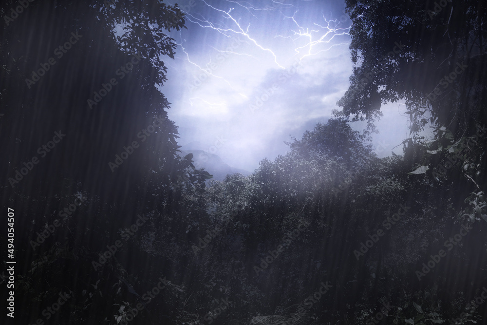 Mother natures mood. Cropped shot a thunderstorm over a mountain as seen through a clearing in the f