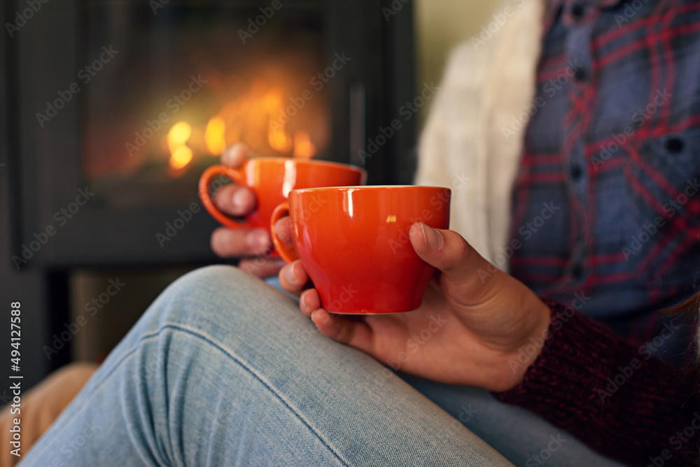 All you need is love and hot chocolate. Cropped shot of a young couple drinking hot chocolate by the