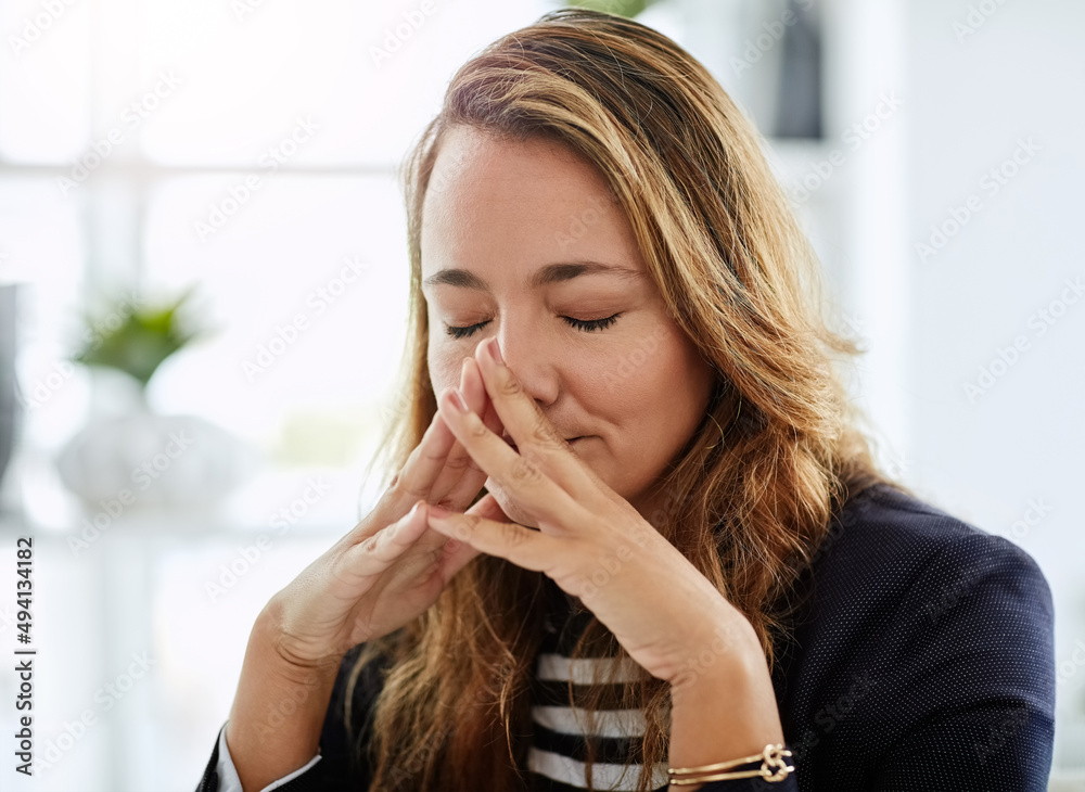 The situation is taking a heavy toll on her. Shot of an attractive businesswoman looking overly stre