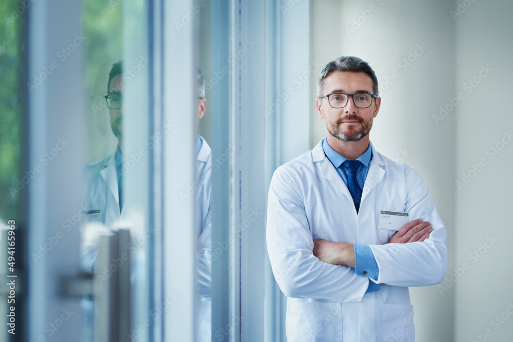 Here to help with any of your healthcare needs. Portrait of a mature doctor standing in a hospital.