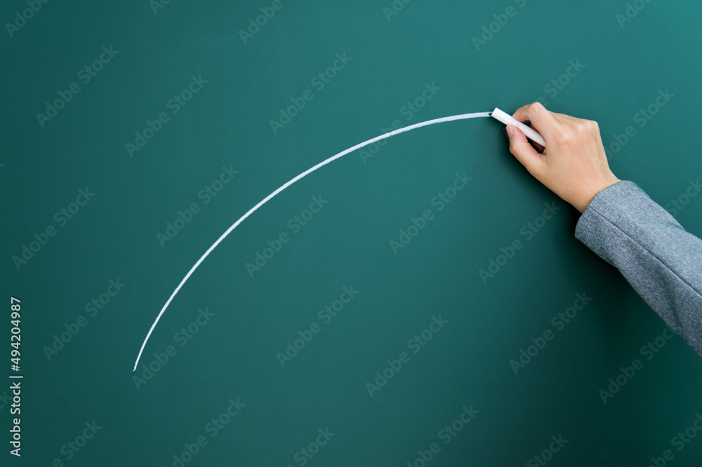 Hand drawing arc on blackboard