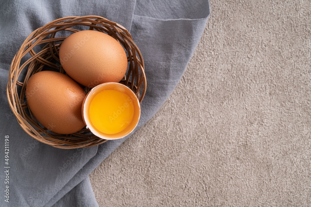 Fresh brown chicken eggs in a plate.