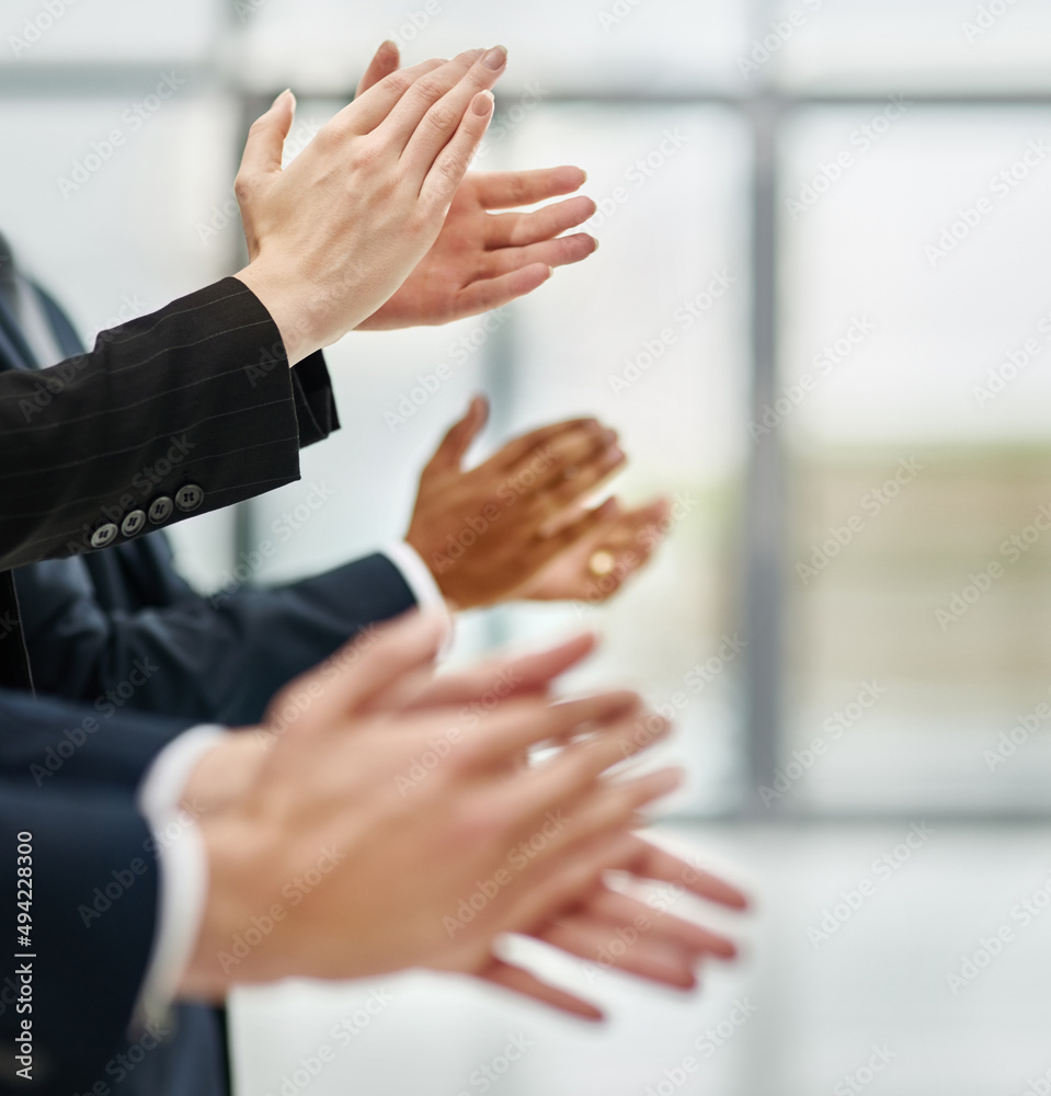 Outstanding presentation. Closeup shot of a group of executives clapping while standing in a row in 