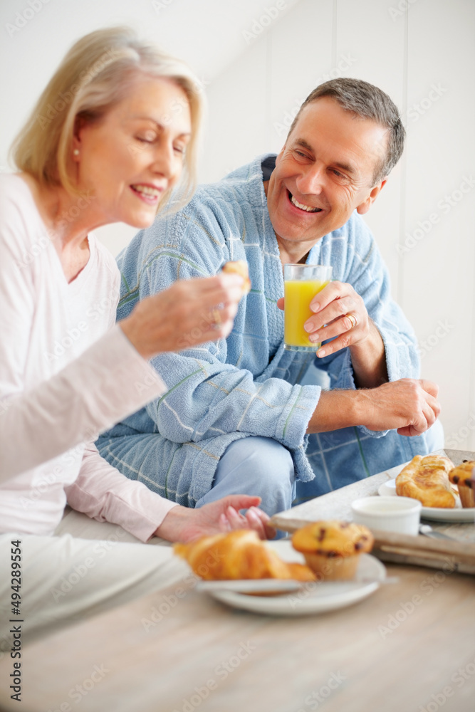 Cheerful mature man and woman having breakfast at home. Portrait of a cheerful mature man and woman 