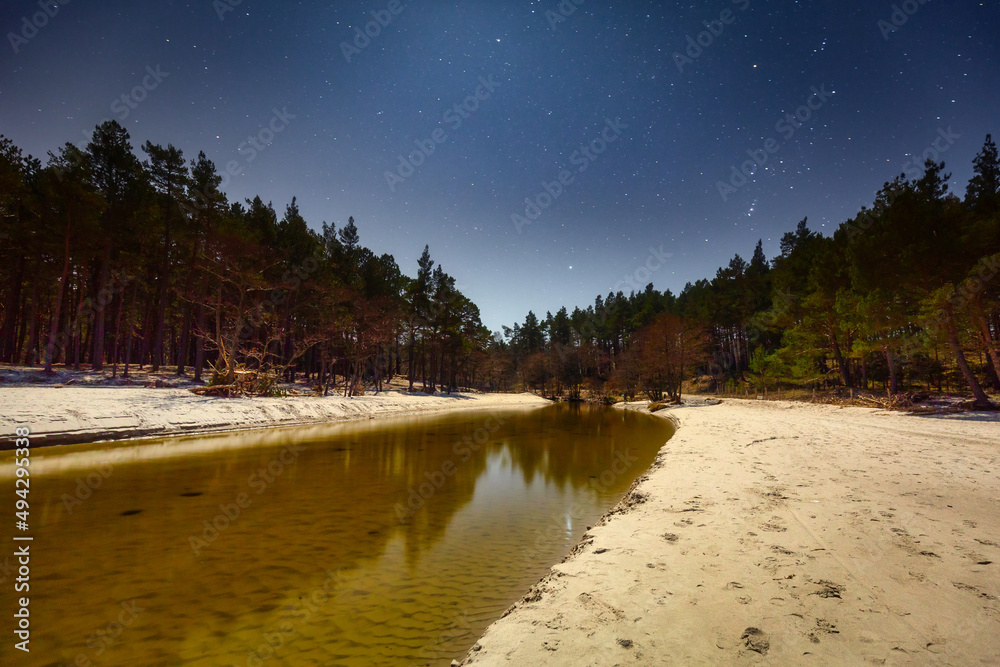 Night scenery of the Piasnica River by the Baltic Sea in Debki, Poland