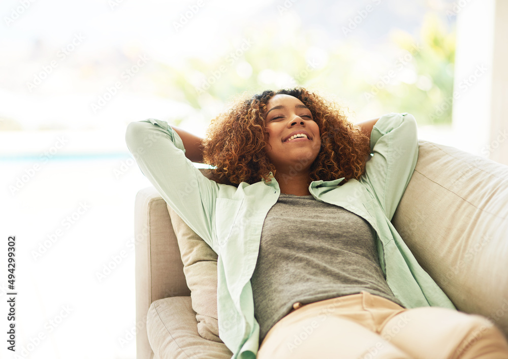 The weekends are for napping. Cropped shot of an attractive young woman resting on her sofa at home.