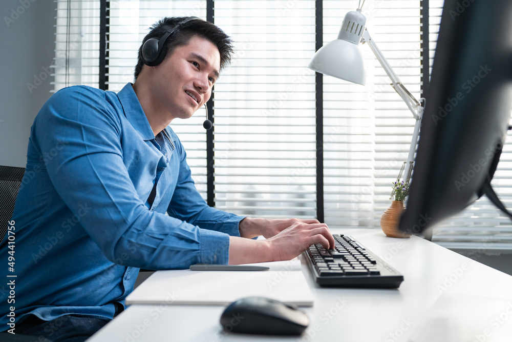 Asian handsome business man using laptop computer working in office.