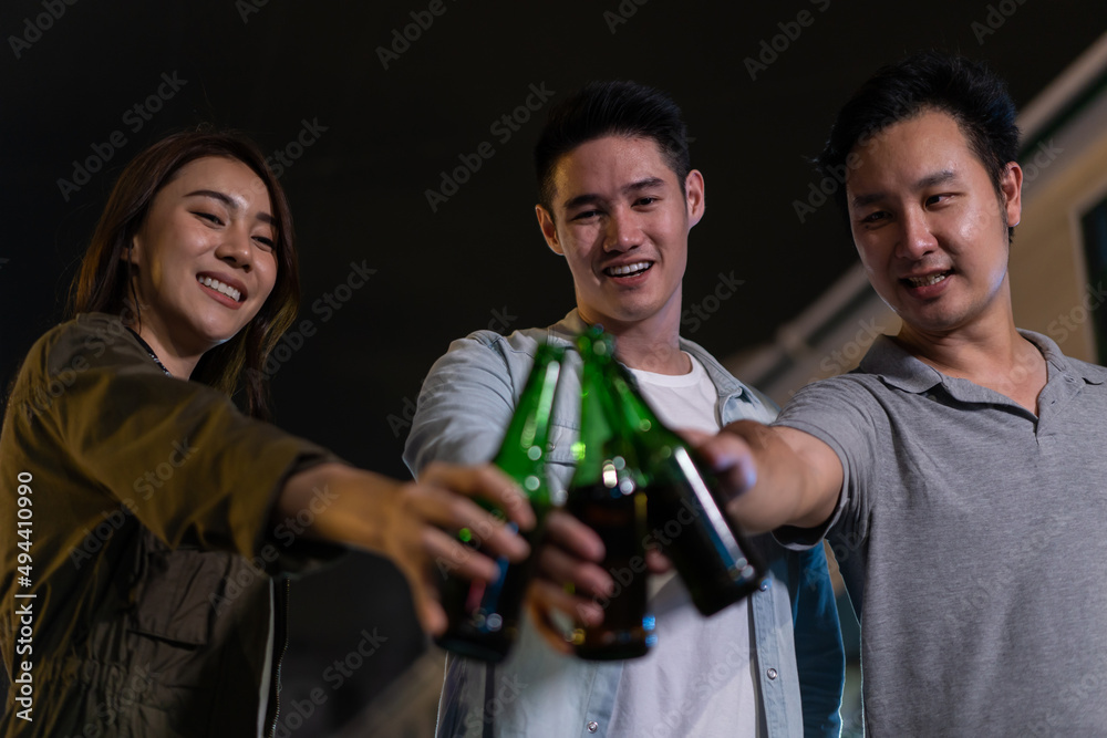 Asian attractive people drinking alcohol with friends and having party