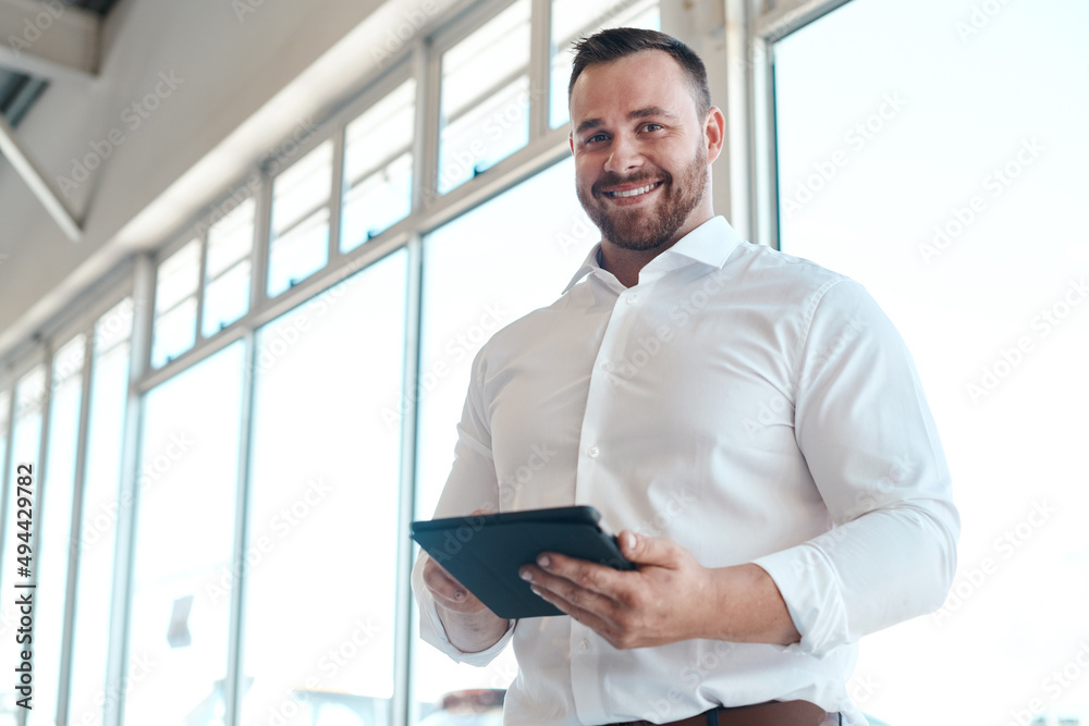 Were going to get you the car of your dreams. Shot of a car salesman using his digital tablet.