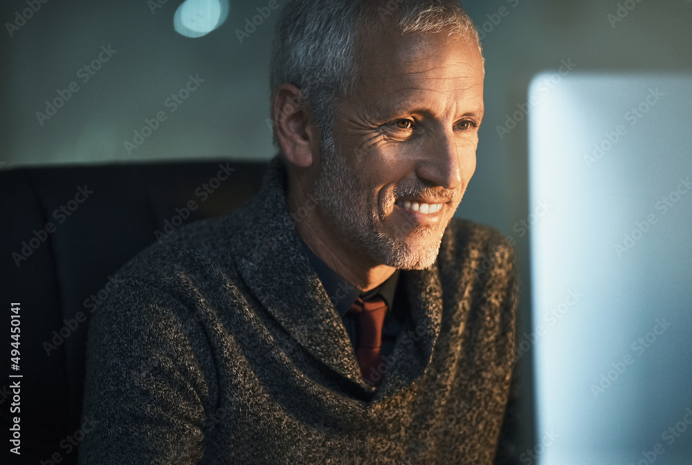 Seeing the benefit of his hard work. Cropped shot of a mature businessman working late at the office