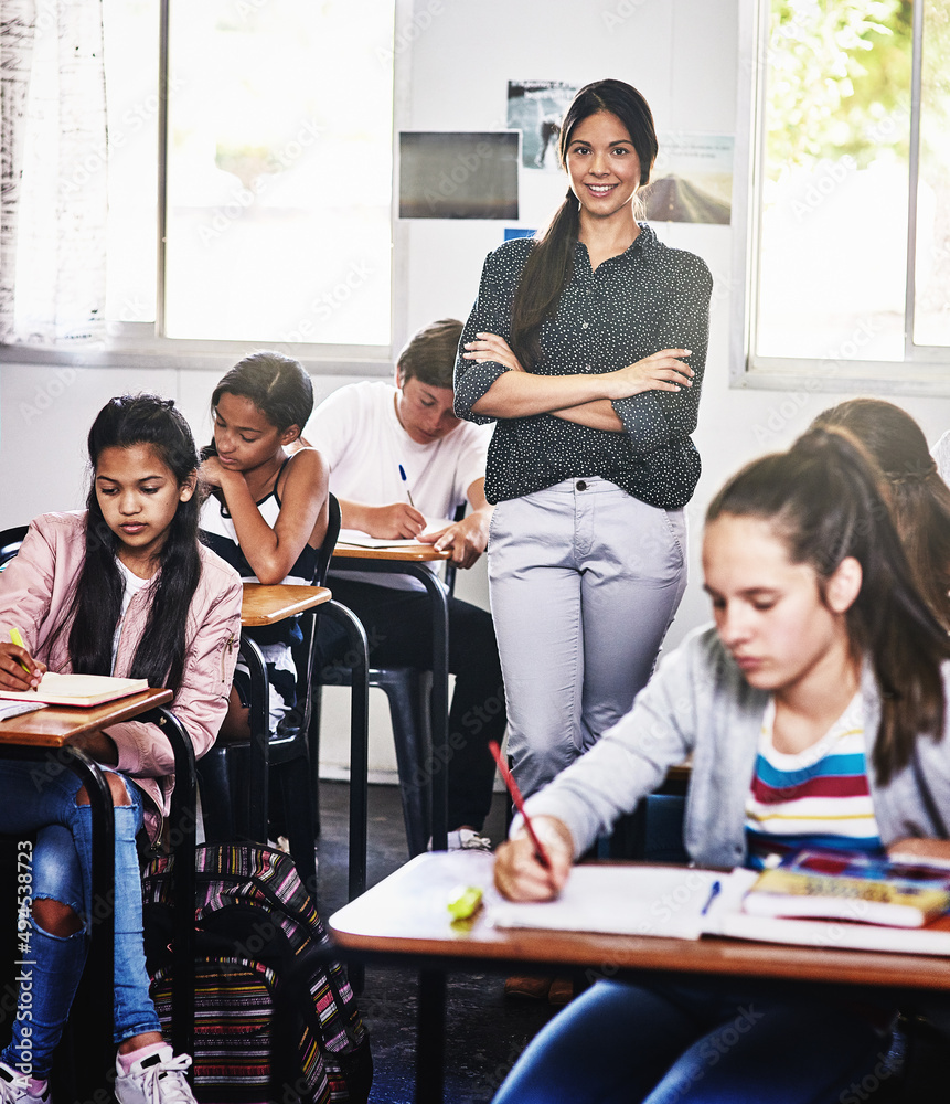 You can trust me with your childs education. Portrait of an attractive young teacher standing with h