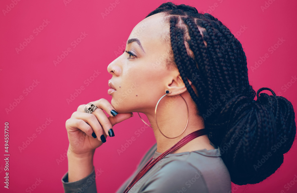 Live life to express not to impress. Profile shot a young woman posing against a pink background.