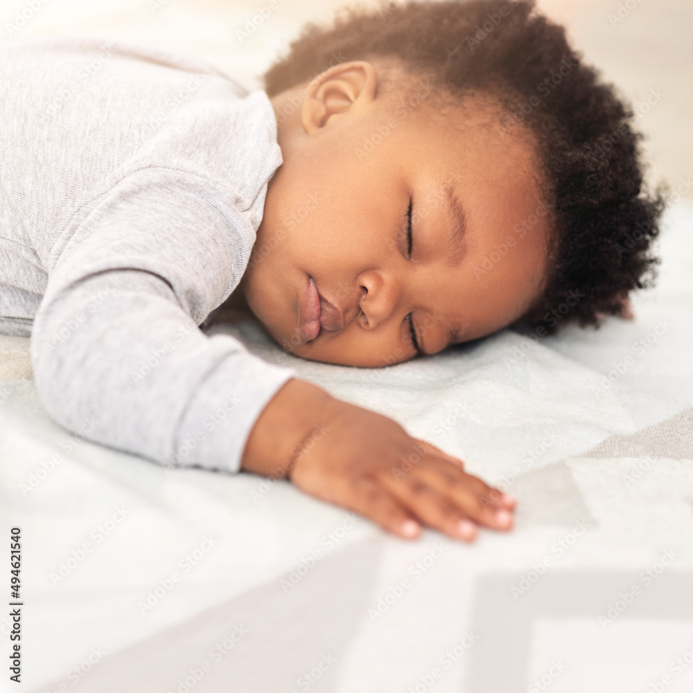 Sweet little dreamer. Shot of a little baby boy sleeping on a bed.