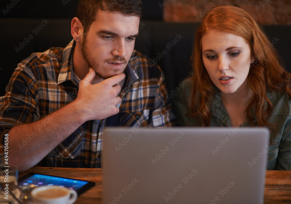 Doing a little browsing while we wait. A loving young couple drinking coffee while sitting with a la