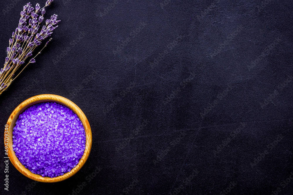 purple spa salt for aroma therapy with lavender flower fragrance on dark background top view copyspa