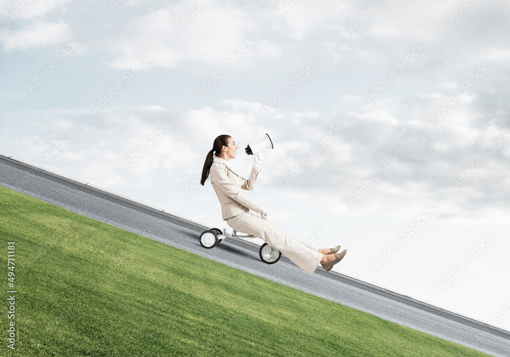 Woman shouting into megaphone and riding