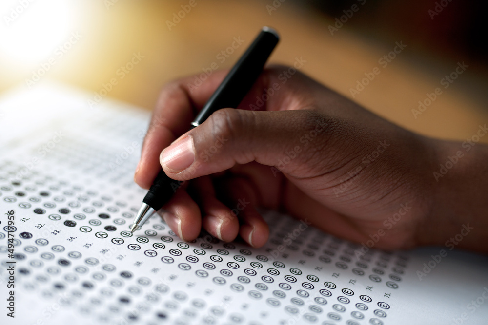 Making his choices. Cropped shot of a person filling out a multiple choice questionnaire.