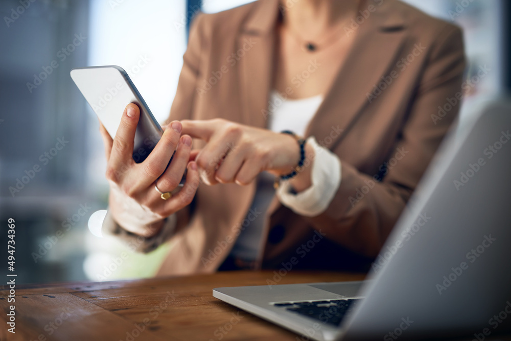 Getting in touch with her network. Closeup shot of an unrecognizable businesswoman using her cellpho