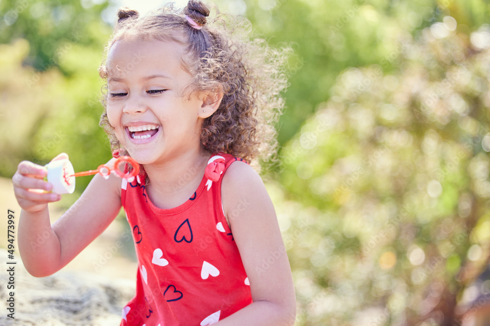 I always get excited about bubbles. Shot of an adorable little girl blowing bubbles at the park.