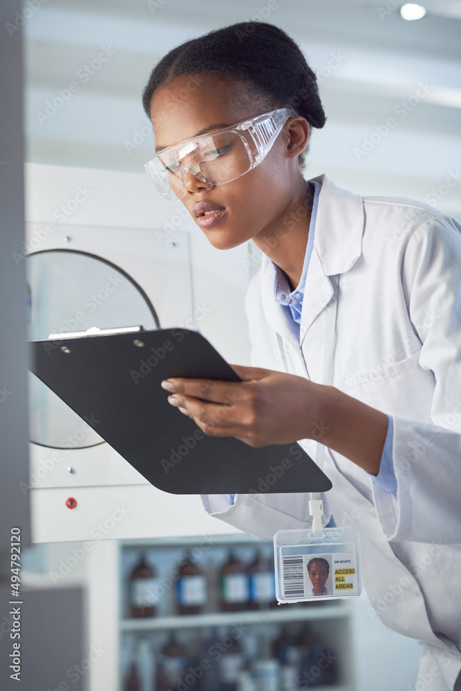 Drawing conclusions from her observations. Shot of a young scientist working in a lab.