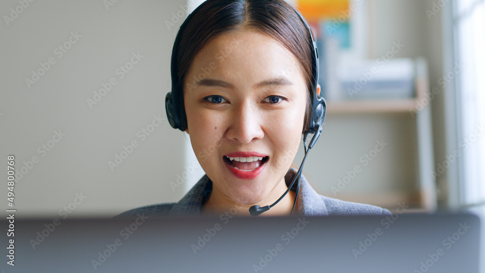 Close up of Young Asian businesswoman wearing headphone, call center, customer service talking on vi